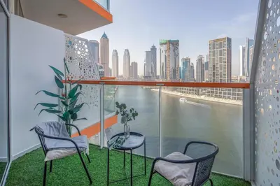 a balcony with chairs and a view of a city at Frank Porter - Millennium Binghatti Residences in Dubai