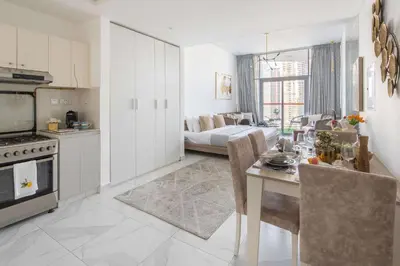 a kitchen and living room with a table and a couch at Frank Porter - Millennium Binghatti Residences in Dubai