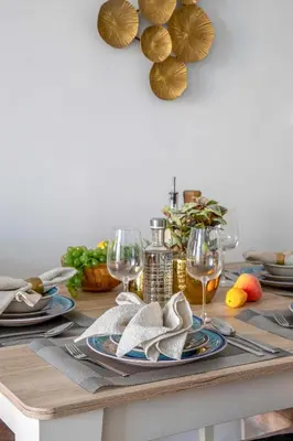 a table with plates of food and wine glasses at Frank Porter - Millennium Binghatti Residences in Dubai