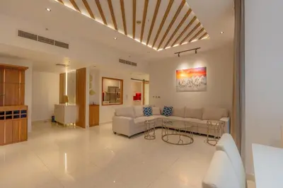 a living room with a couch and a table at Luxury 3BR Stunning Burj Khalifa View in Dubai