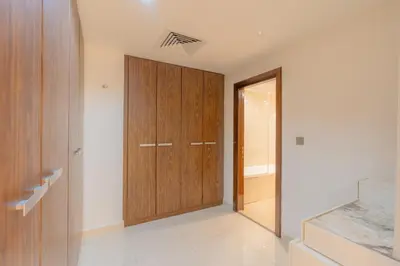 a hallway with a wooden door in a house at Luxury 3BR Stunning Burj Khalifa View in Dubai