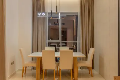 a dining room with a table and chairs at Luxury 3BR Stunning Burj Khalifa View in Dubai