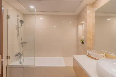 a bathroom with a shower and a tub and a sink at Luxury 3BR Stunning Burj Khalifa View in Dubai