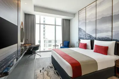 a hotel room with a large bed and a desk at Grand Millennium Business Bay in Dubai