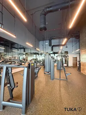 a gym with a row of tables and chairs at 2BR Forte Tower 1 Downtown 3mn Burj Khalifa in Dubai