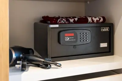 a black microwave sitting on a shelf with a telephone at Luxury 2 Bedroom in Golf Suites Dubai Hills in Dubai