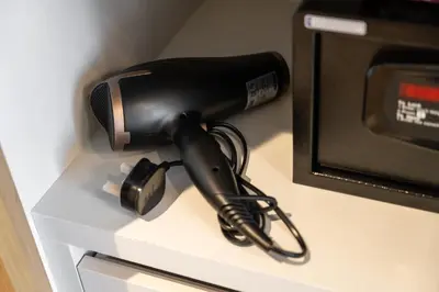 a hair dryer sitting on a counter next to a microwave at Luxury 2 Bedroom in Golf Suites Dubai Hills in Dubai