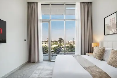 a bedroom with a bed and a large window at Luxury 2 Bedroom in Golf Suites Dubai Hills in Dubai