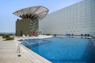 a large swimming pool in front of a building at Chic Studio in Goldcrest Views, JLT in Dubai