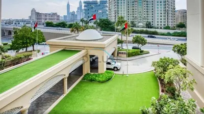 a view of a building with a green lawn at Lovely Studio in Murjan 2, Jumeirah Beach Residence by Deluxe Holiday Homes in Dubai