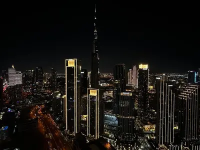 a city skyline at night with a tall building at Downtown Skyline & Burj Khalifa Views Dubai in Dubai