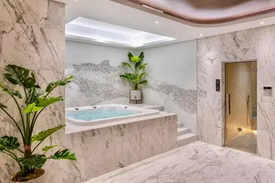 a bathroom with a jacuzzi tub and plants at Downtown Skyline & Burj Khalifa Views Dubai in Dubai