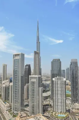 a group of tall buildings in a city at Downtown Skyline & Burj Khalifa Views Dubai in Dubai