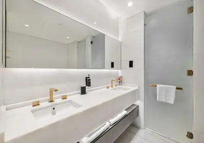a white bathroom with a sink and a mirror at Daniels Sea View 2BR at Five Palm Jumeirah in Dubai