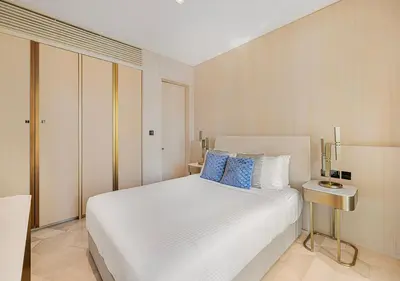 a bedroom with a large white bed with blue pillows at Daniels Sea View 2BR at Five Palm Jumeirah in Dubai