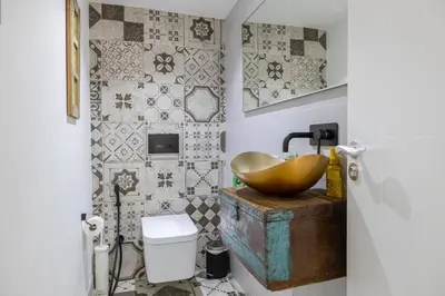 a bathroom with a bowl sink and a toilet at Coastal Themed 4BR Townhouse with Pool in JVC in Dubai