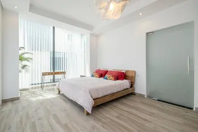 a bedroom with a bed with red pillows on it at Coastal Themed 4BR Townhouse with Pool in JVC in Dubai