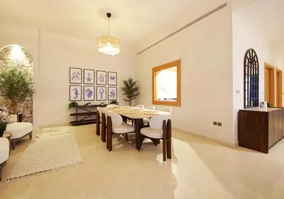 a dining room with a table and chairs at Breathtaking Villa With Roof Garden and Beach access in Dubai