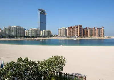 a large body of water next to a city with tall buildings at Luxury Villa With breathtaking View And Beach Access in Dubai