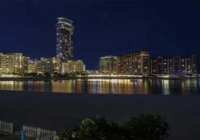 a city skyline at night with the water and buildings at Luxury Villa With breathtaking View And Beach Access in Dubai