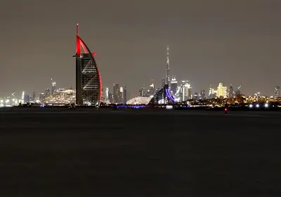 a city skyline at night with a tall building at Luxury Villa With breathtaking View And Beach Access in Dubai