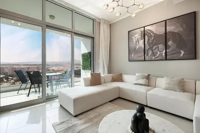 a living room with a couch and a table at Cozy Urban 2BR Apartment in DEC Tower Marina in Dubai