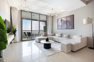 a living room with a white couch and a table at Cozy Urban 2BR Apartment in DEC Tower Marina in Dubai