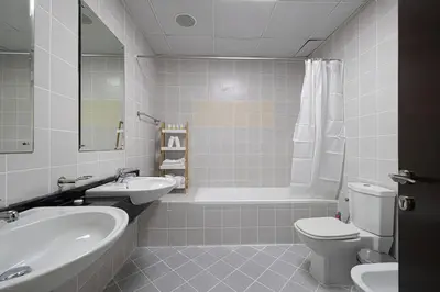 a bathroom with a sink and a toilet and a tub at Cozy Urban 2BR Apartment in DEC Tower Marina in Dubai