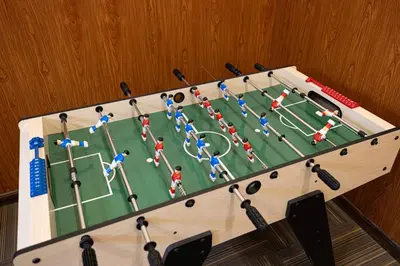 a model of a soccer game in a wooden box at Cozy Urban 2BR Apartment in DEC Tower Marina in Dubai