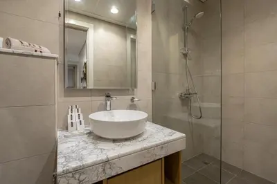 a bathroom with a sink and a shower at Stunning 3BR w Panoramic Views in Aykon City in Dubai