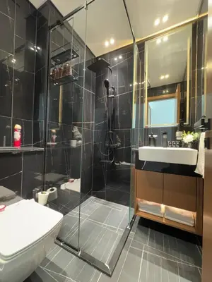a bathroom with a shower and a toilet and a sink at Trendy & Elegant 1br In Jvc in Dubai