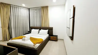 a bedroom with a bed and a large window at Elegant 2-Bedroom Apartment with Private Balconies & En-Suite Luxury in Meydan Avenue in Dubai