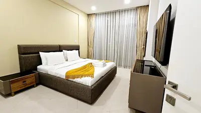 a bedroom with a bed and a flat screen tv at Elegant 2-Bedroom Apartment with Private Balconies & En-Suite Luxury in Meydan Avenue in Dubai