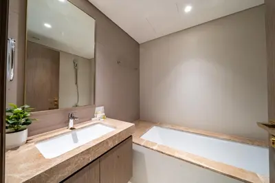 a bathroom with a sink and a mirror at Homes Beyond l Elegant 2BR with Wide Sea Views in Dubai