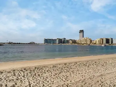 a beach with a city in the background at Homes Beyond l 2BR Panoramic Skyline & Sea View in Dubai