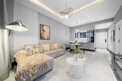 a living room with a couch and a table at Business Bay 1BR Canal Views, Pool, Gym & Near Burj Khalifa in Dubai