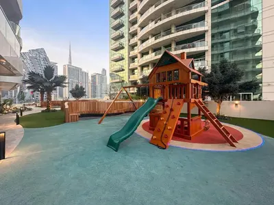 a playground with a slide and a play structure at Business Bay 1BR Canal Views, Pool, Gym & Near Burj Khalifa in Dubai