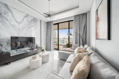 a living room with a couch and a tv at Business Bay 1BR Canal Views, Pool, Gym & Near Burj Khalifa in Dubai