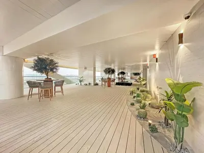 a room with tables and potted plants in a building at Business Bay 1BR Canal Views, Pool, Gym & Near Burj Khalifa in Dubai
