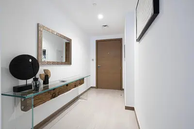 a bathroom with a glass counter and a mirror at Mahogany 2 - 2BR 6PAX - Infinity Pool & Near Metro in Dubai