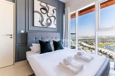 a bedroom with a large bed with towels on it at Modern 1-BR Golf Course View in Golf Vita in Dubai