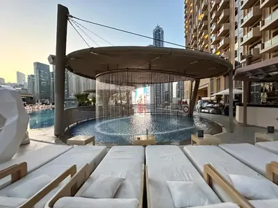 a swimming pool in a building with a building at Trophy - Marina Address Studio - Full Marina View in Dubai