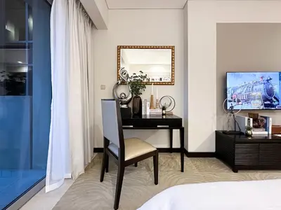 a bedroom with a desk and a mirror at Trophy - Marina Address Studio - Full Marina View in Dubai
