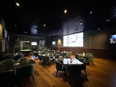 a restaurant with chairs and tables in a room at Trophy - Marina Address Studio - Full Marina View in Dubai