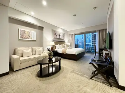 a hotel room with a bed and a couch at Trophy - Marina Address Studio - Full Marina View in Dubai