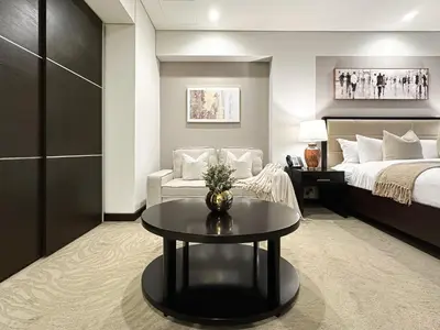a hotel room with a bed and a coffee table at Trophy - Marina Address Studio - Full Marina View in Dubai