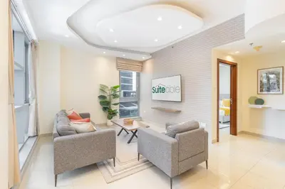 a living room with two chairs and a table at Sophisticated and Elegant 2BR in Downntown Dubai in Dubai