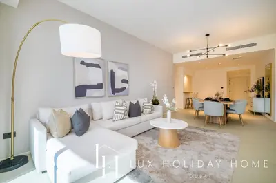a living room with a white couch and a table at LUX The Premium Marina Sea View Suite in Dubai