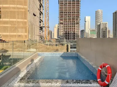 a swimming pool on the roof of a building at FIRST CLASS Studio Stylish Living in Dubai