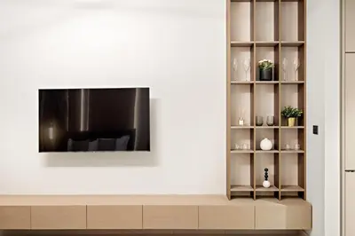 a living room with a television on a wall at FIRST CLASS Studio Stylish Living in Dubai